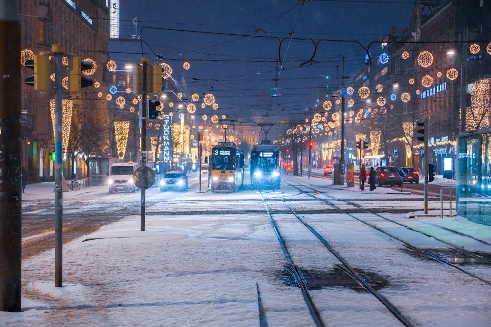 two trams with lights on