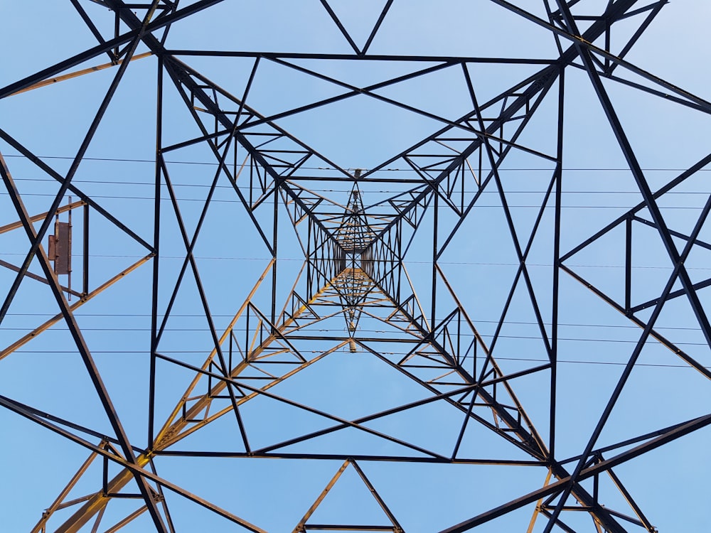 low angle photography of brown metal electric tower