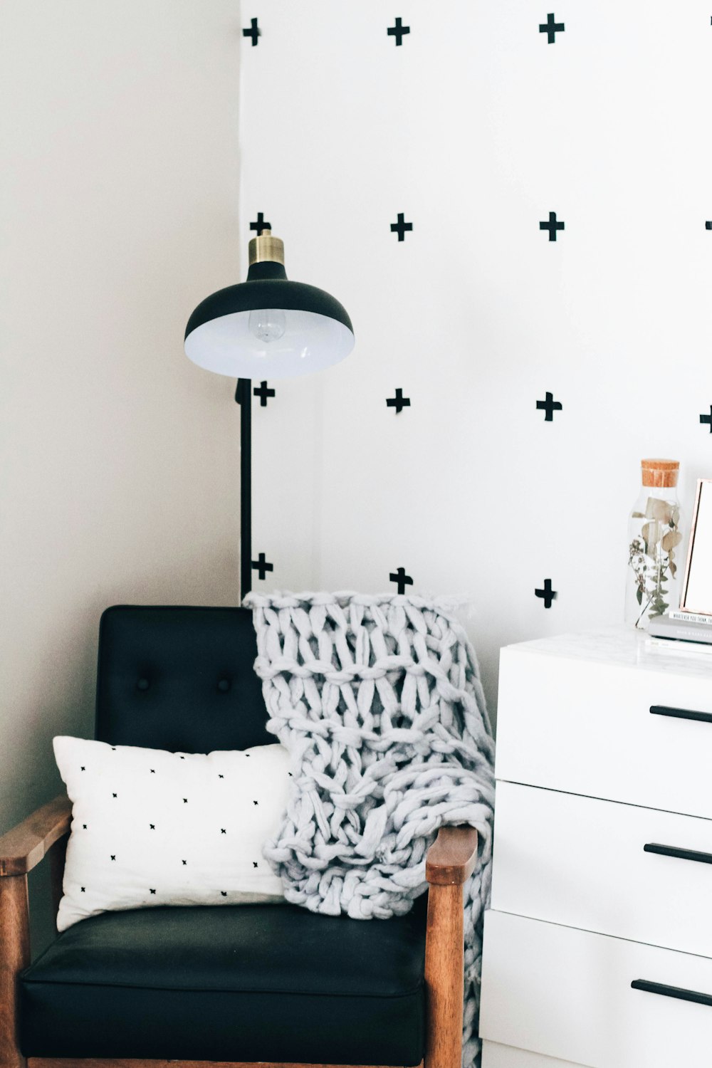 a black and white room with a black chair