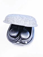 A pair of wireless earbuds resting inside their sleek charging case.