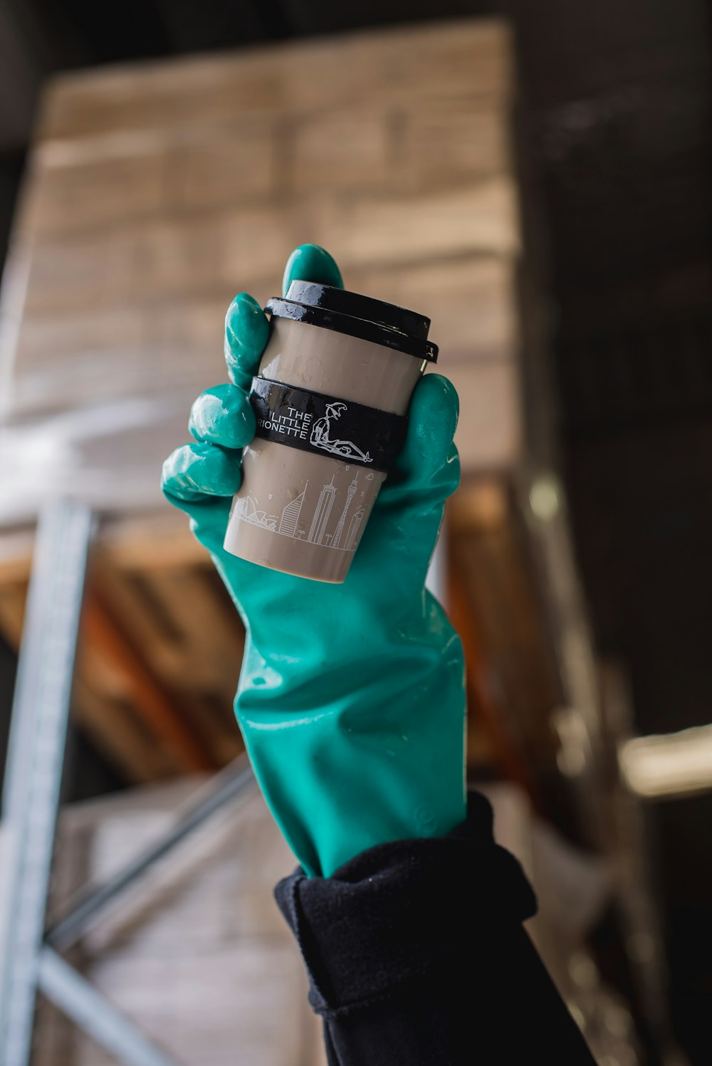 person holding black and gray disposable cup