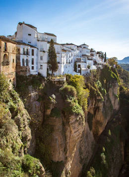 a white village on a cliff in the mountains