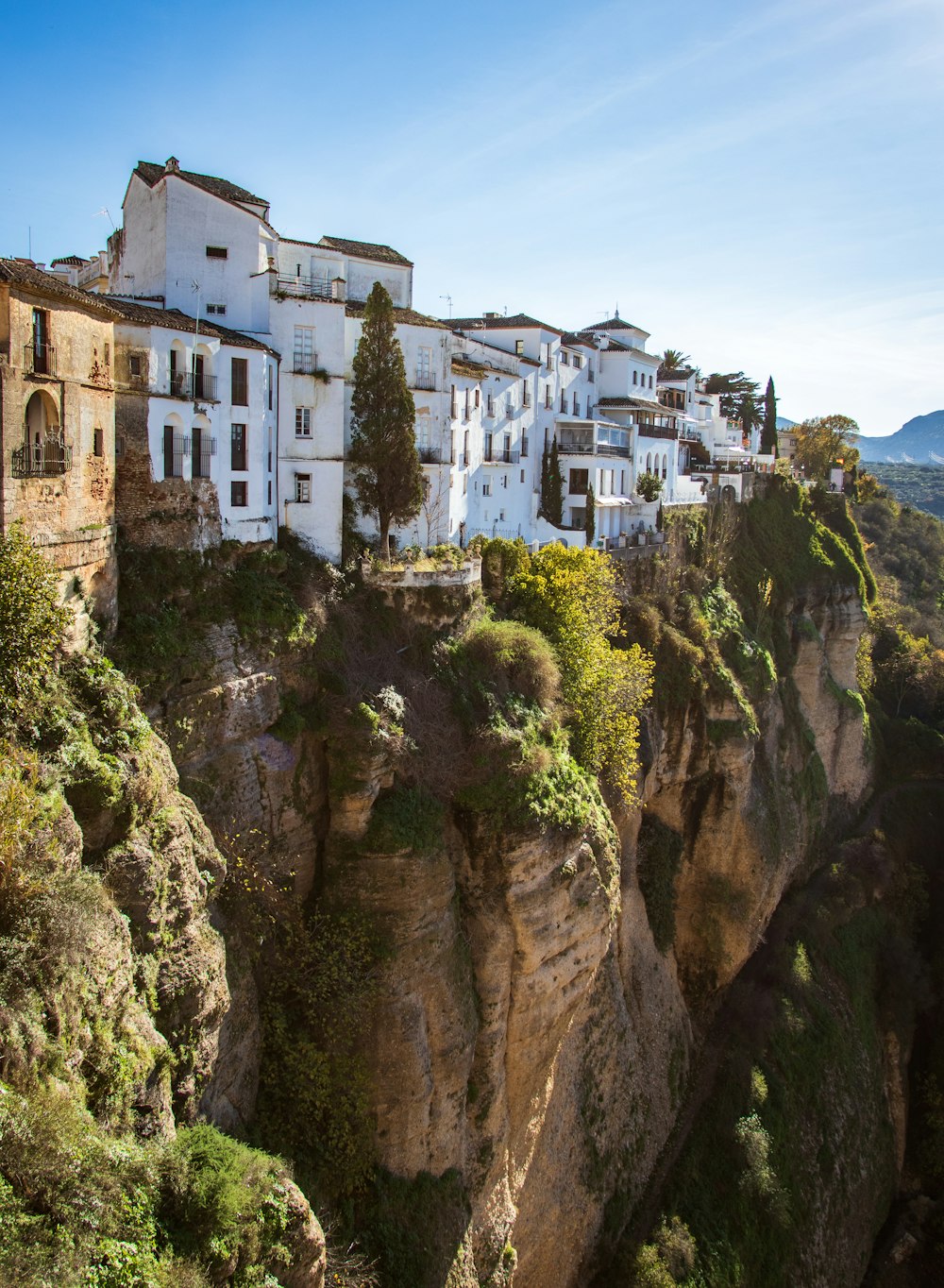 a white village on a cliff in the mountains