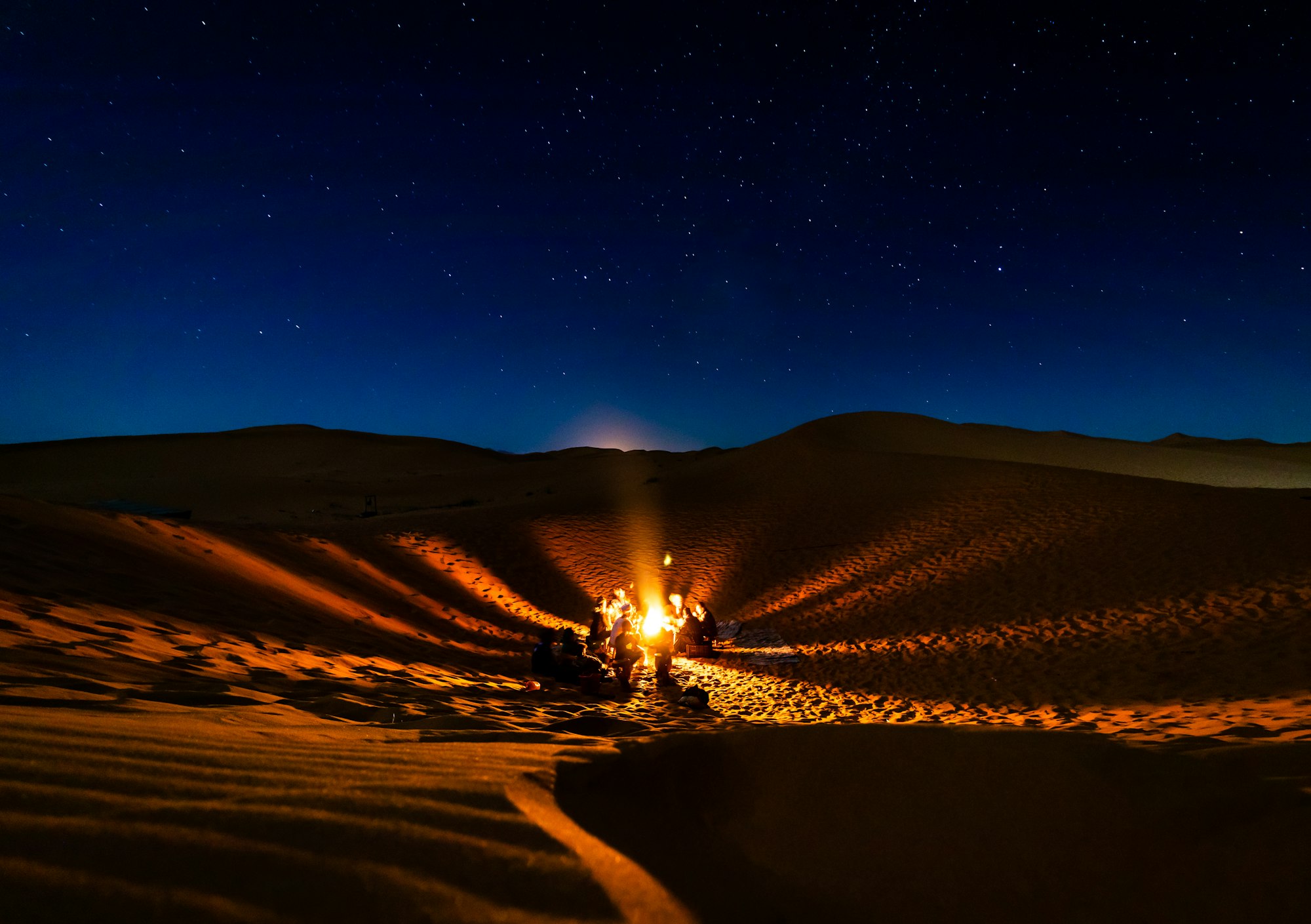 Playing on drums at the campfire, Sahara