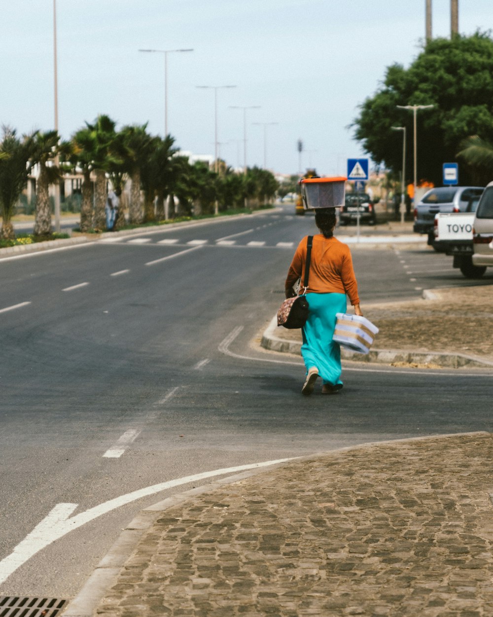 woman carrying white tote box