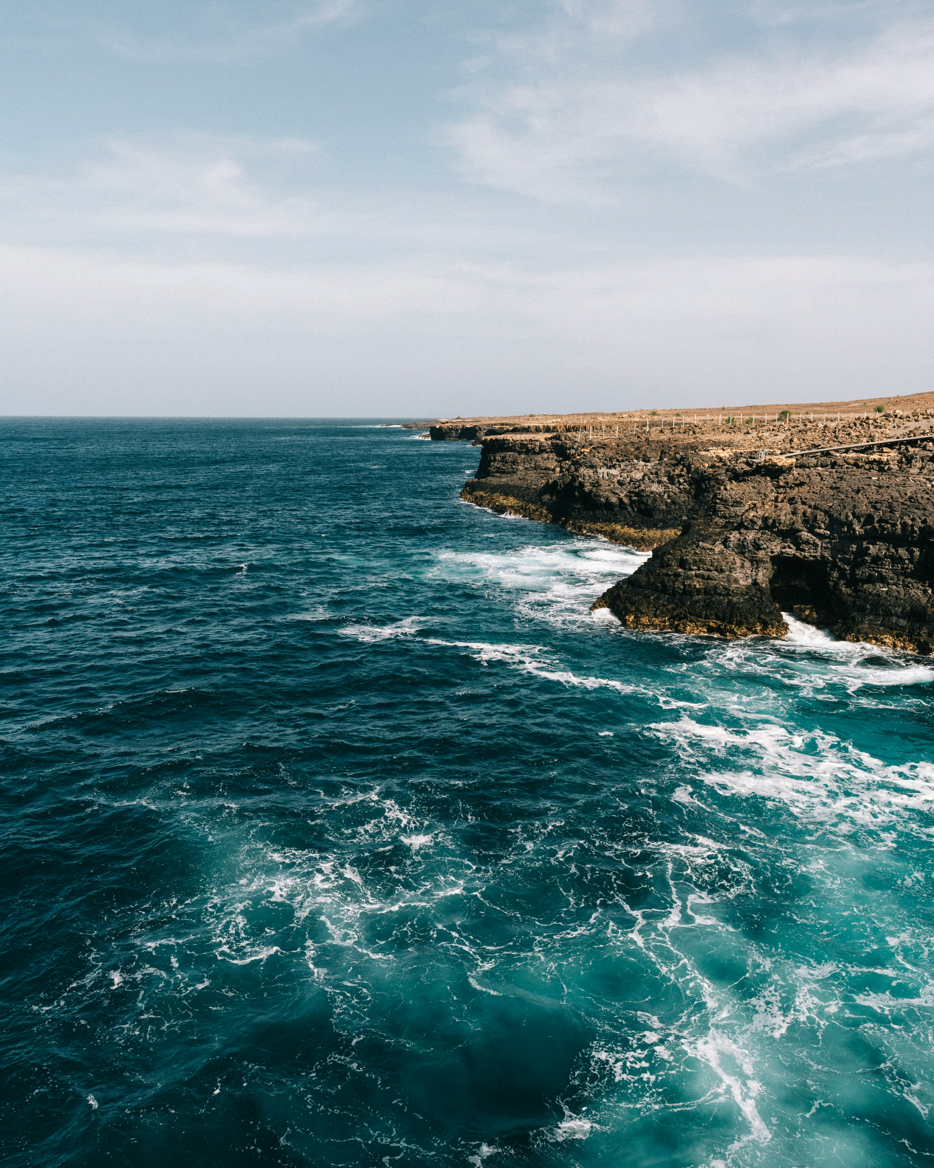 clear blue sea surrounded by rocks