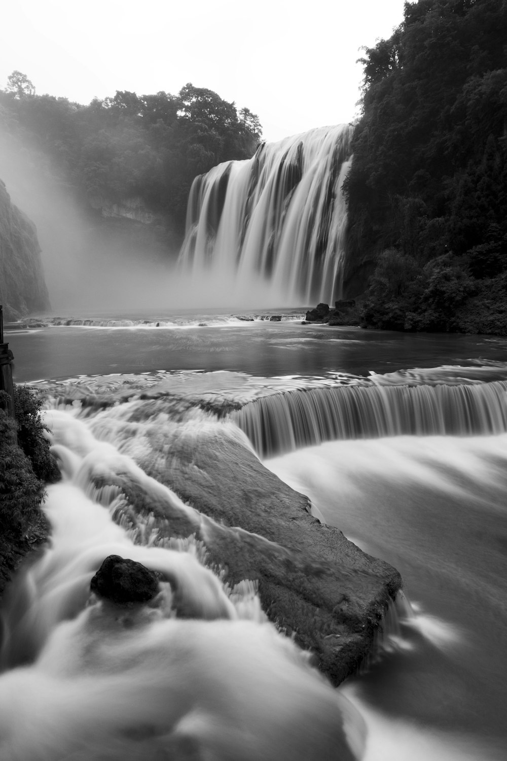 grayscale photography of waterfall