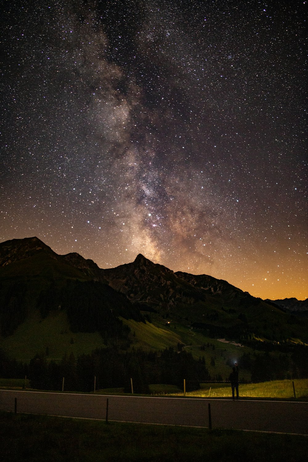 silhouette of mountains under starry night