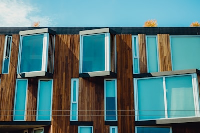 Modern wooden building facade showcasing recycled construction materials in natural light.