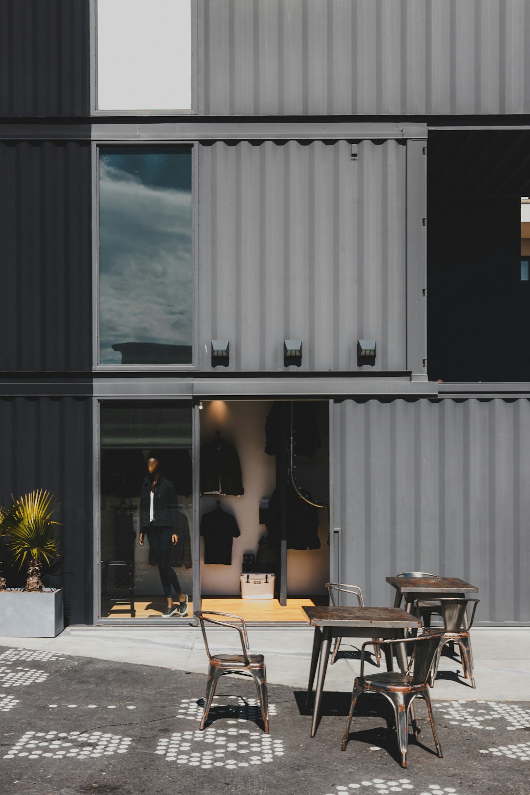 empty chairs and tables outside building during daytime