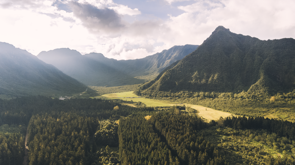 aerial photography of mountain under cloudy sky