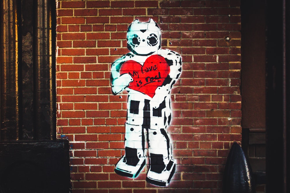 white robot painted brick wall