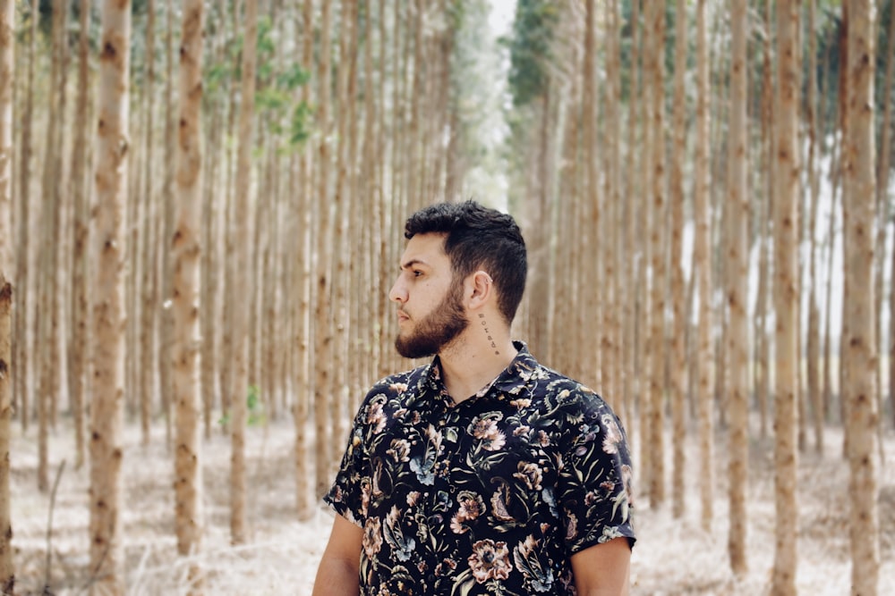 shallow focus photo of man in black and pink floral button-up T-shirt