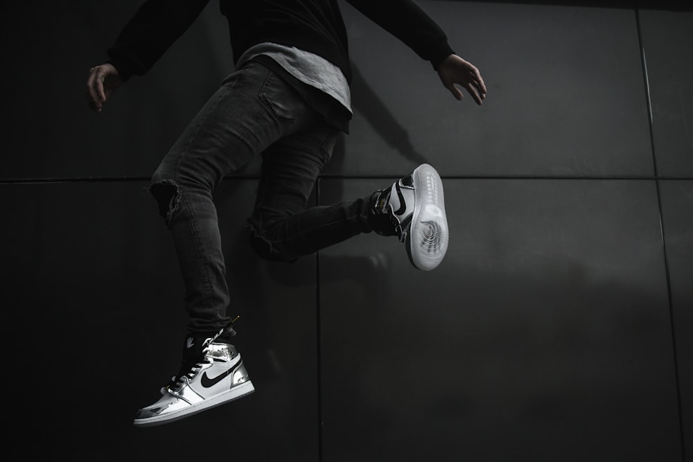 man jumping near wall