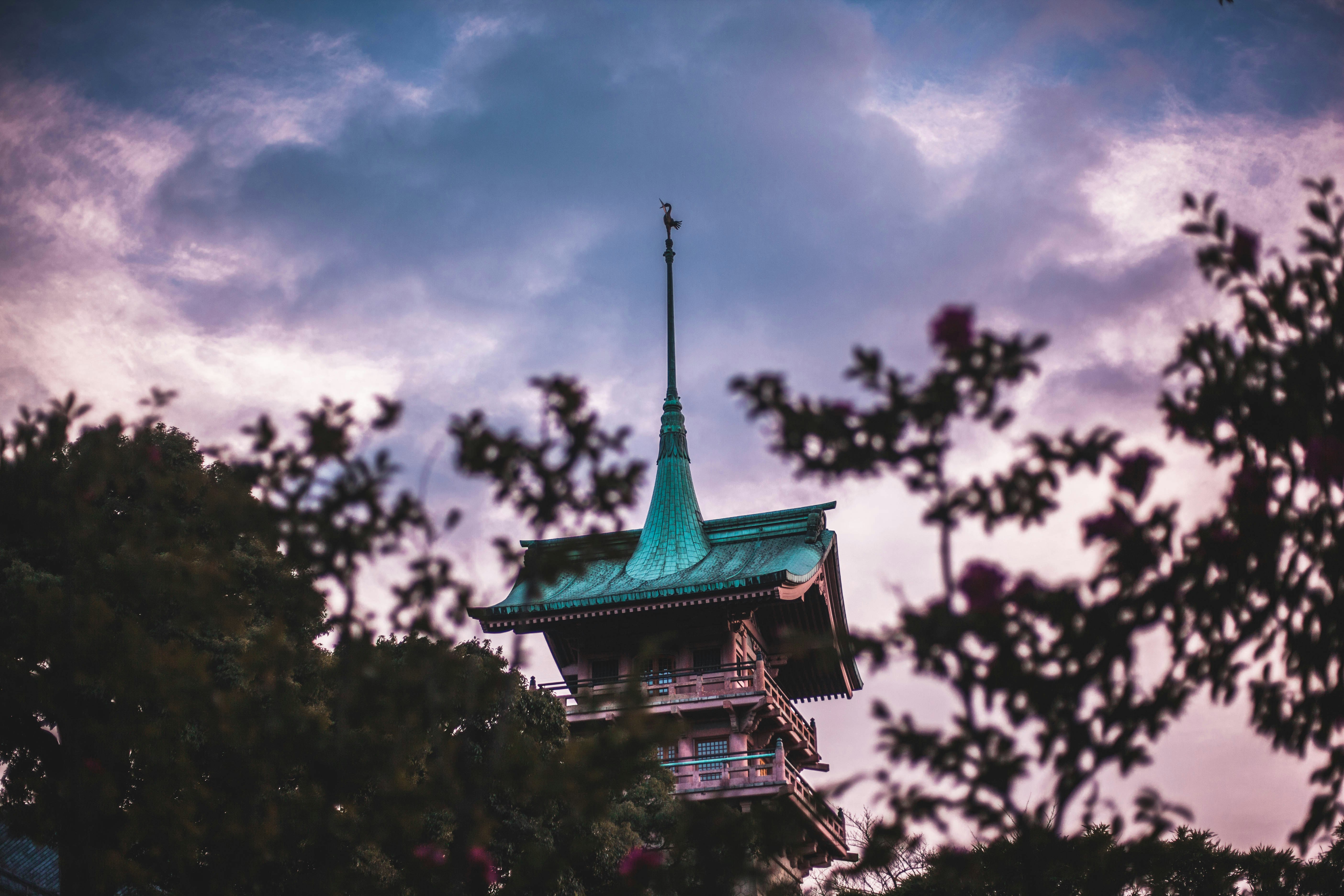 low angle photo of teal and brown pagoda