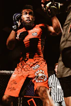 Portrait of MMA Ref Pro in referee gear, standing confidently in the octagon.