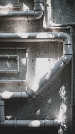 Water pipes and valves in a building mechanical room, the kind of system that failed at a Clark County school campus