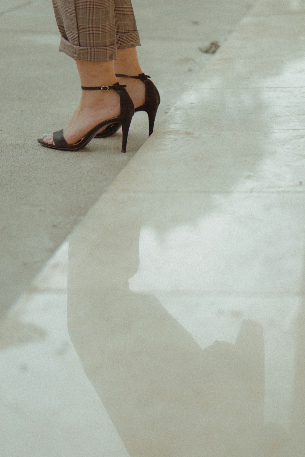 woman wearing black open-toe ankle strap heeled sandals