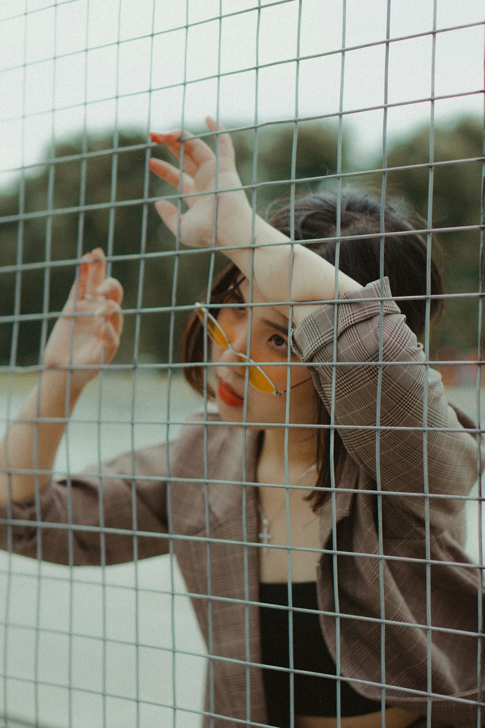 woman leaning on fence