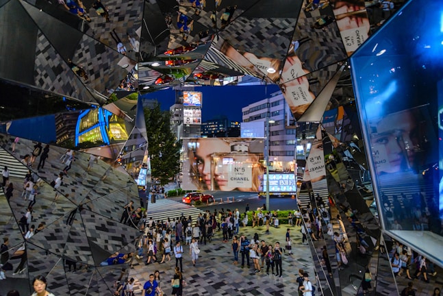 A bustling virtual plaza filled with avatars interacting under a glowing digital sky.