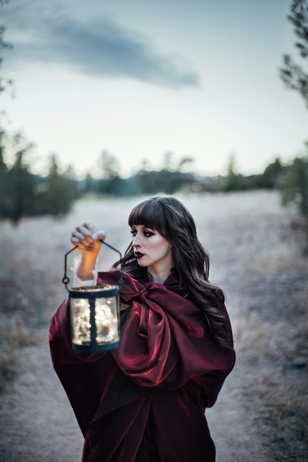 woman carrying camping lantern