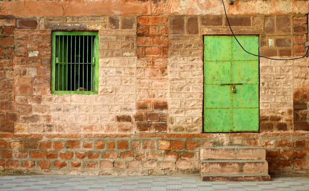 closed green metal door during daytime