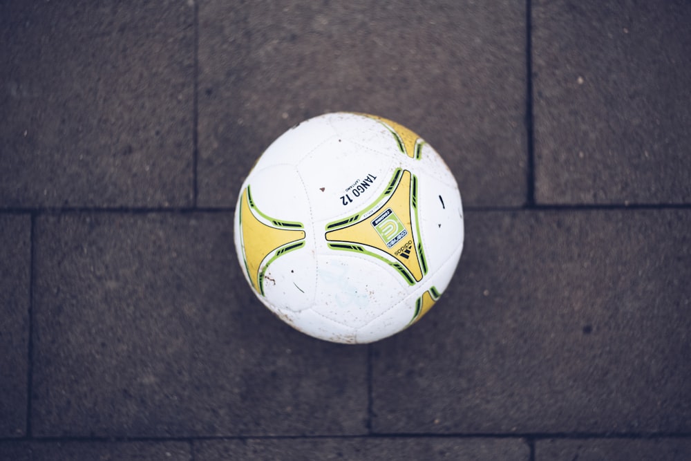white, yellow, and green soccer ball