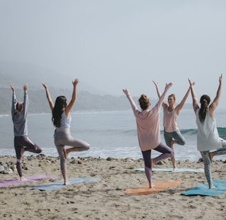 five woman standing on seashore