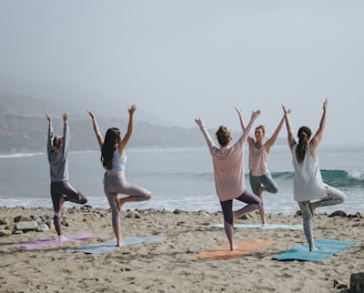 five woman standing on seashore