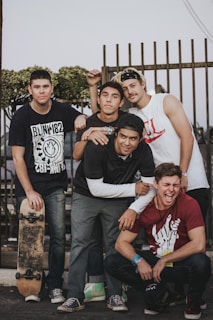 A group of diverse men laughing and enjoying a casual outdoor gathering.