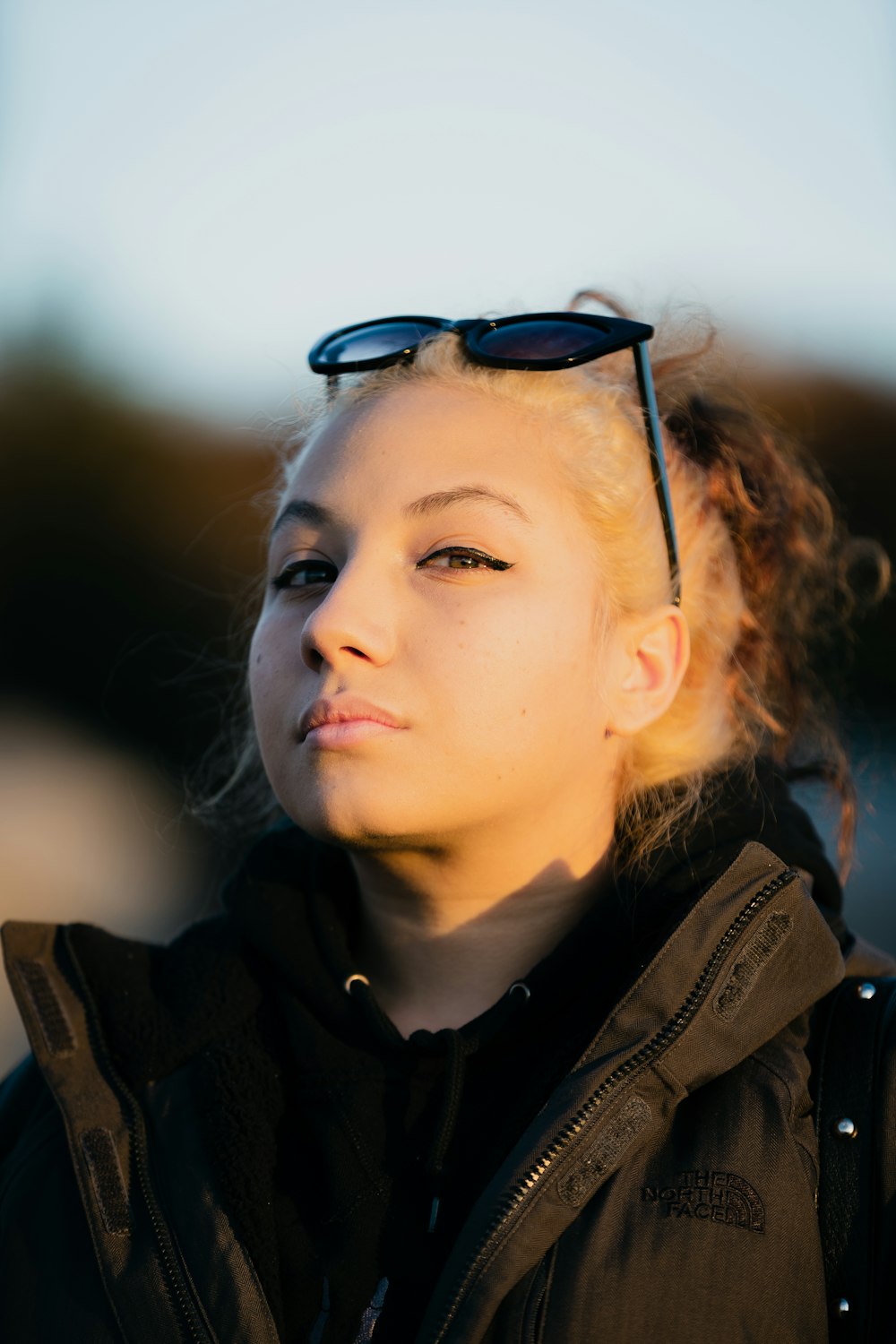 woman in black coat on selective focus photography