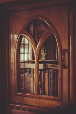 shallow focus photo of brown wooden display cabinet