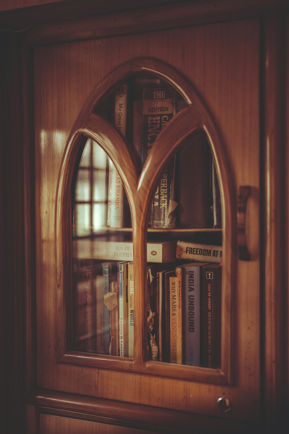 shallow focus photo of brown wooden display cabinet
