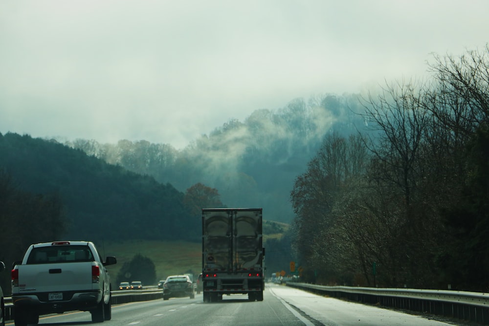 gray box truck on concrete road during daytime