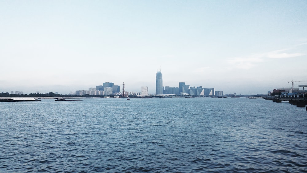 tall city buildings seen across the harbor