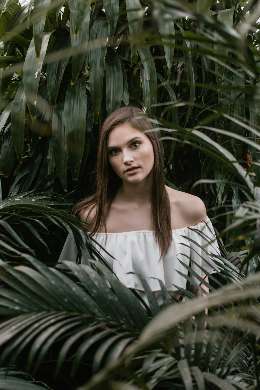 woman standing beside plants