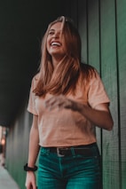woman in orange shirt laughing