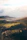 Scenic photo of a Yorkshire village with rolling hills and quaint cottages during golden hour