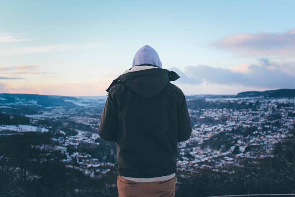 person on high ground under blue sky