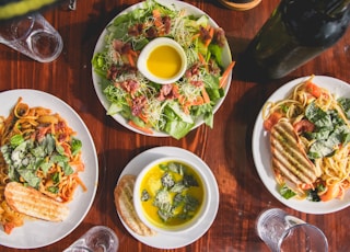 four assorted dishes on wooden surface