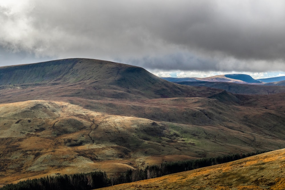 brown hills under gray clouds