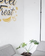 Cozy lounge corner with plants and comfortable seating inviting casual meetings.