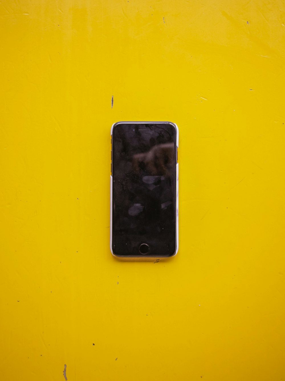silver iPhone 5 on yellow surface