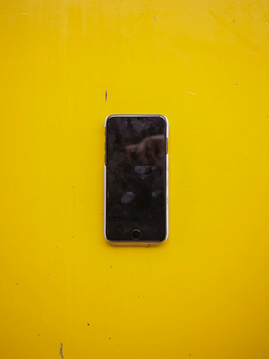 silver iPhone 5 on yellow surface