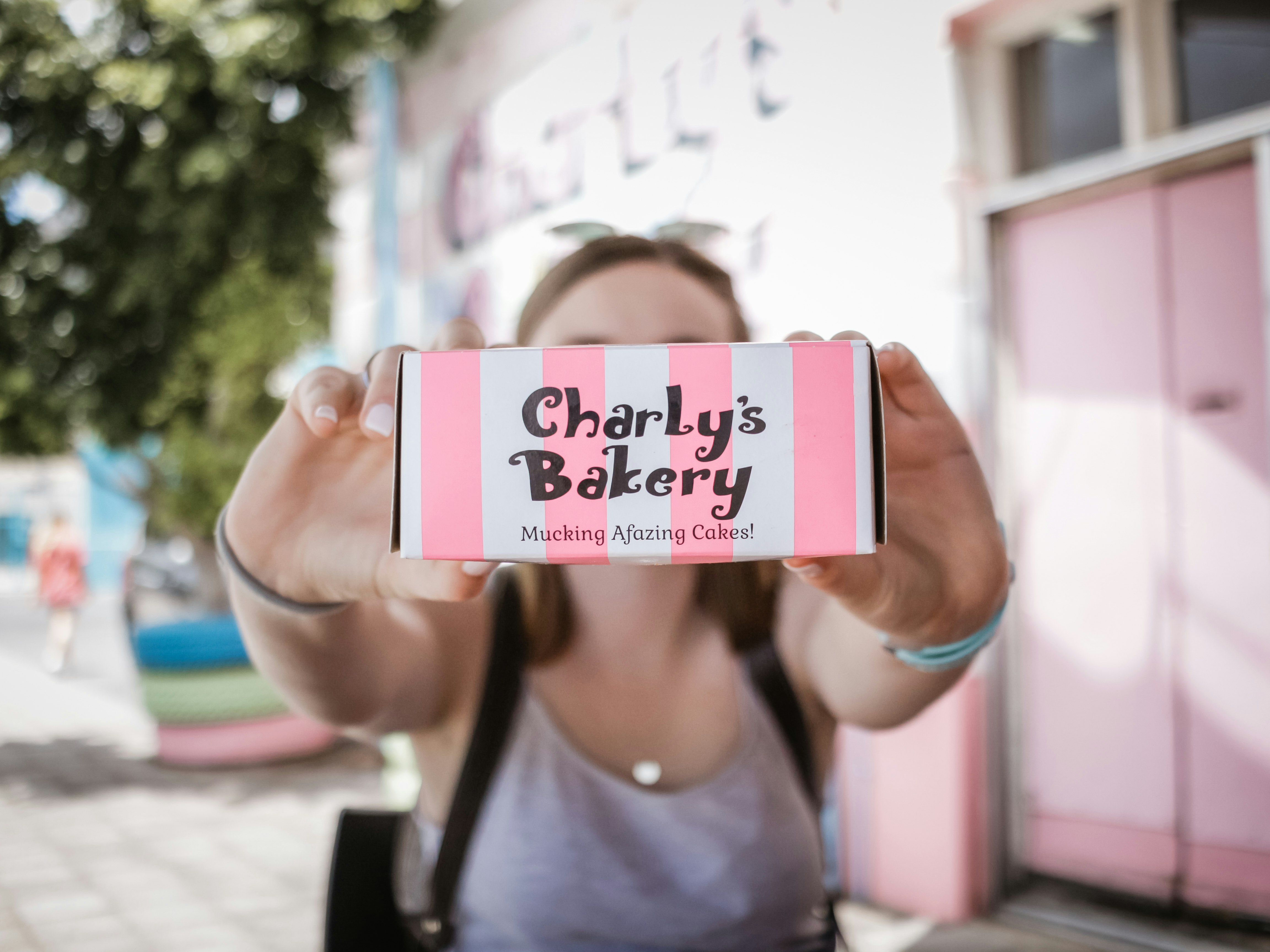woman holding Charly's Bakery box