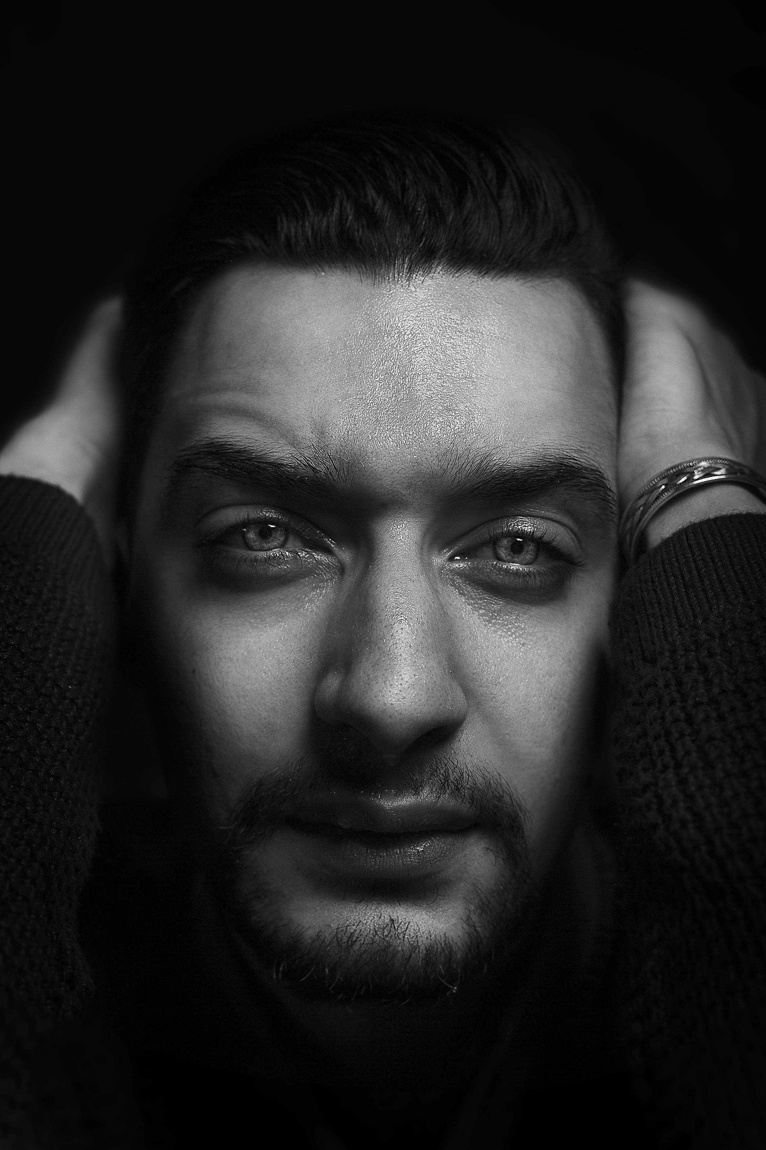 grayscale photography of man holding his head