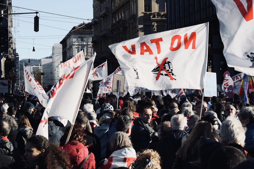 group of people carrying Vat On flag