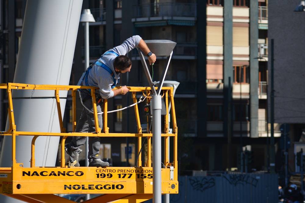 man fixing gray tower