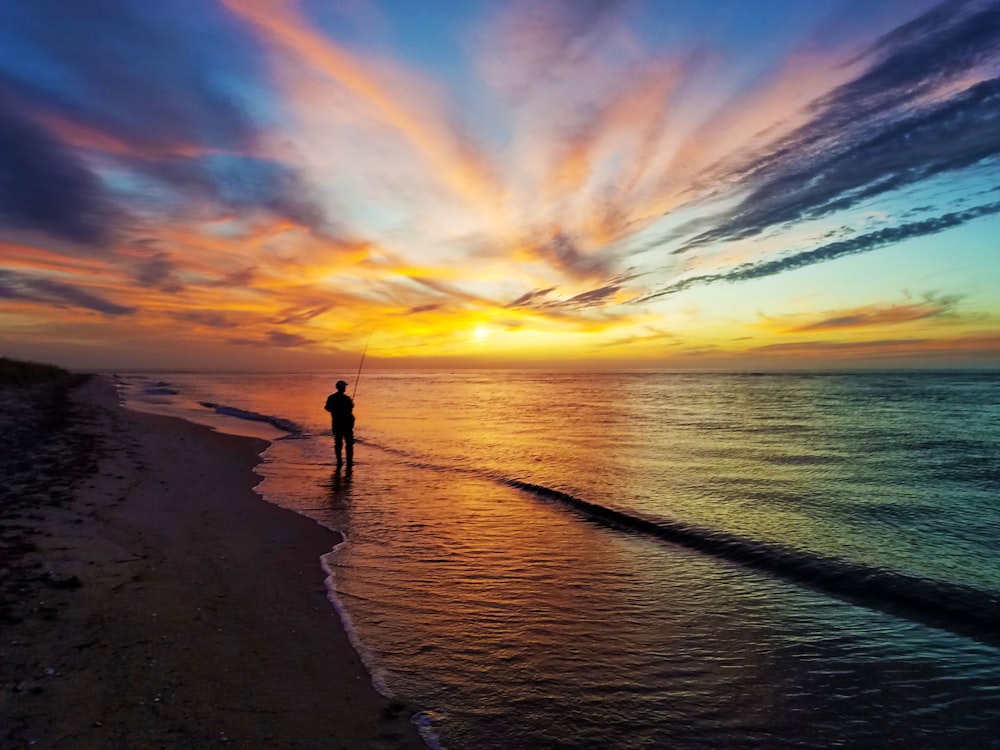 person standing on seashore