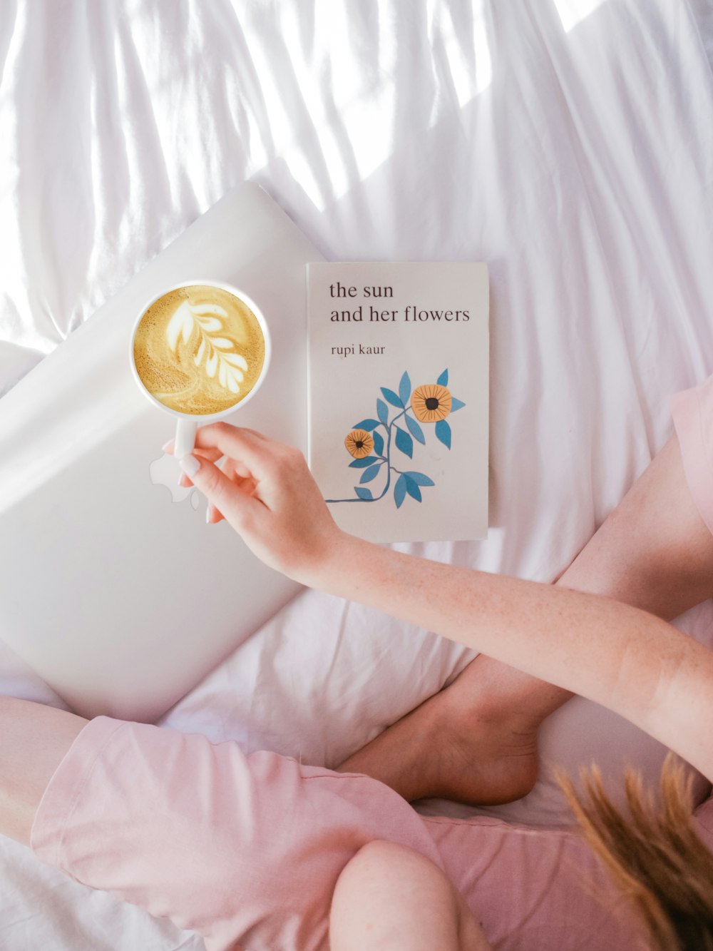 person holding coffee in white teacup